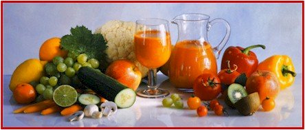 Photo of various fruits and vegetables and a pitcher and glass of juice.